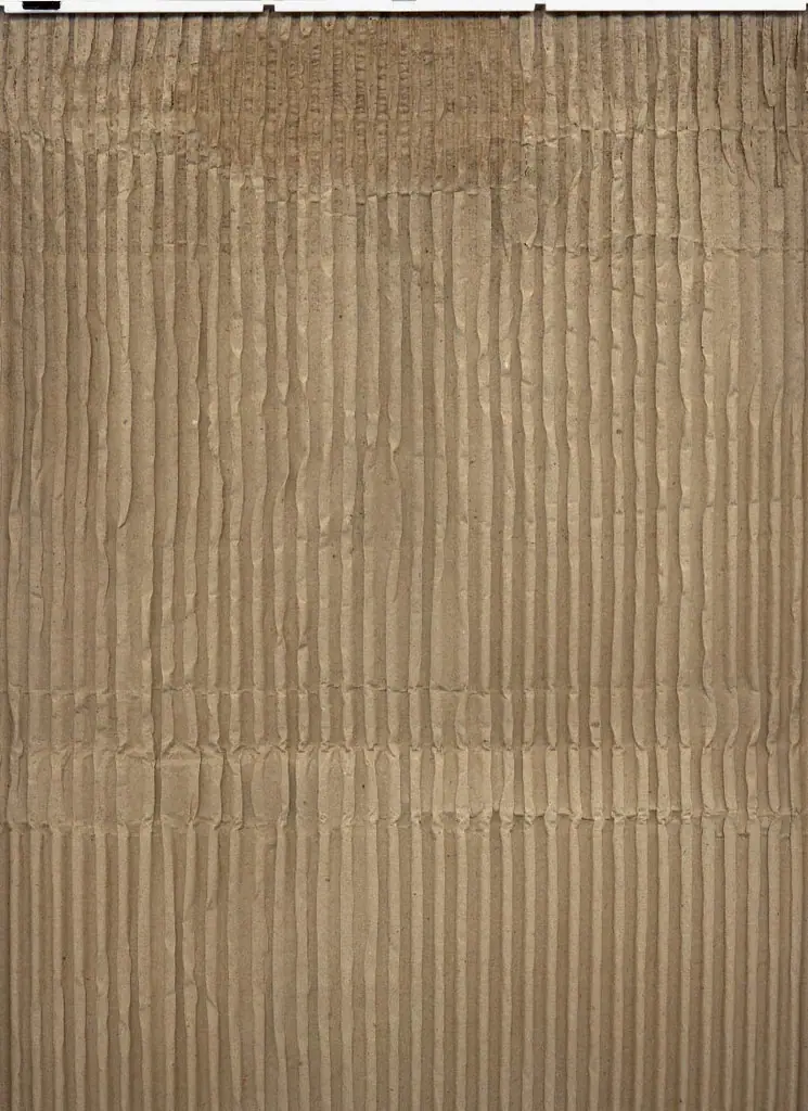 Close-up of the cut edge of corrugated board showing its flutes